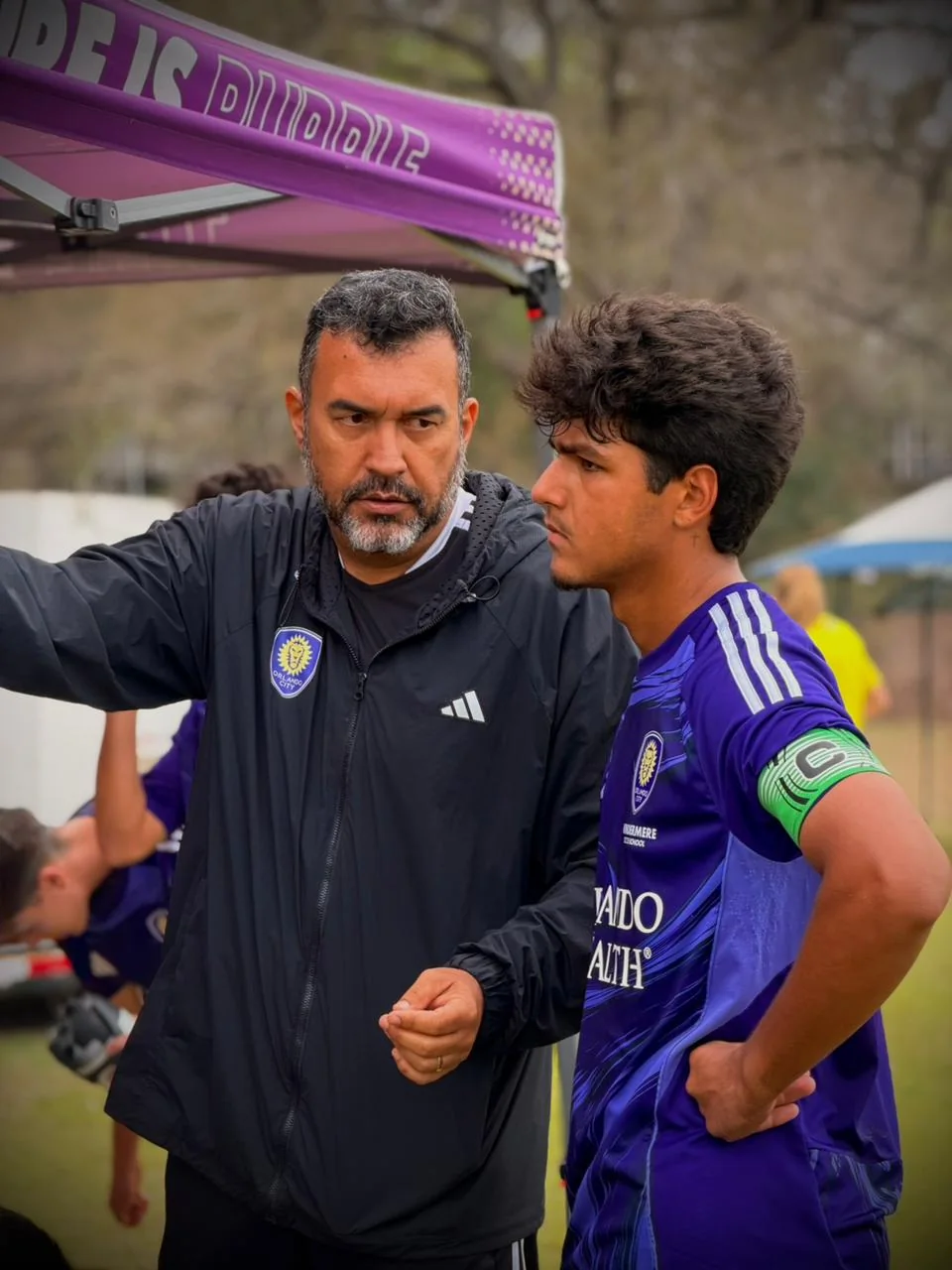 Coach speaking individually with a soccer player